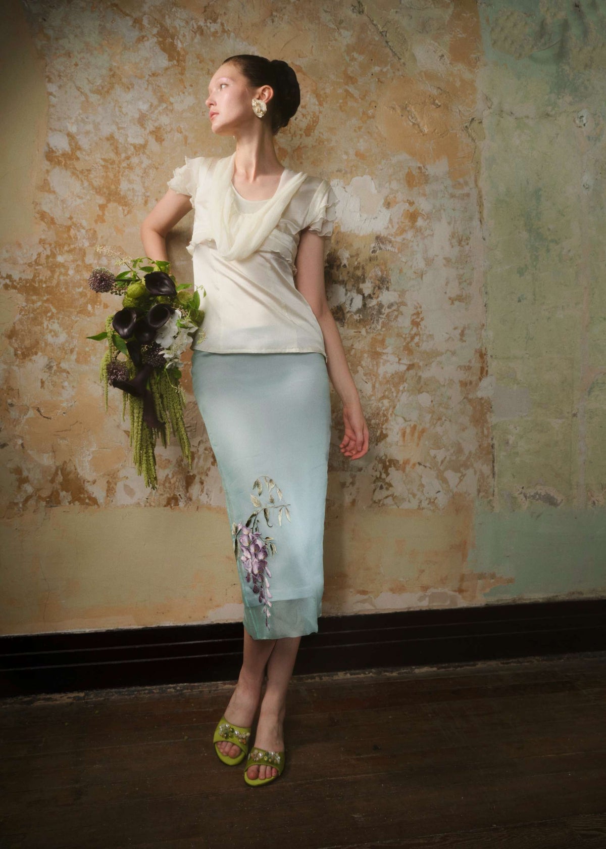 Mint silk organza embroidered midi skirt styled with an ivory blouse and a bouquet of green florals